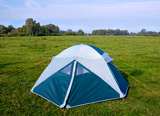 Image showing Private camping tent on the meadow near the river.