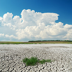 Image showing white clouds over cracked desert
