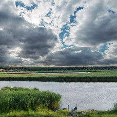 Image showing low darken clouds over river