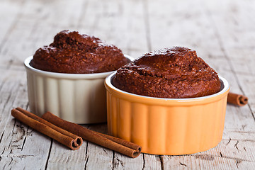 Image showing two fresh baked browny cakes and cinnamon sticks