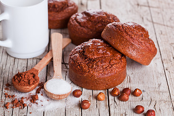 Image showing fresh baked browny cakes, milk, sugar, hazelnuts and cacao 