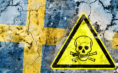 Image showing Old cracked wall with poison warning sign and painted flag