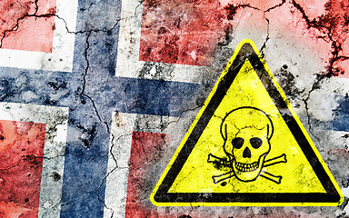 Image showing Old cracked wall with poison warning sign and painted flag