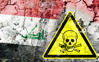 Image showing Old cracked wall with poison warning sign and painted flag