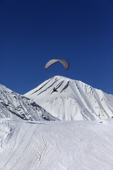 Image showing Skydiver in sunny snowy mountains