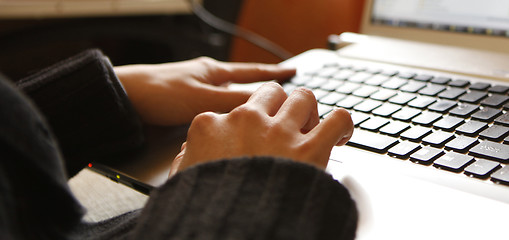 Image showing Young woman working on laptop