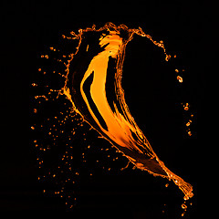 Image showing orange water splash isolated on black