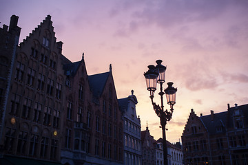 Image showing Silhouettes of city center houses in Bruges against beautiful su