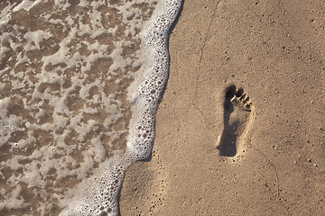 Image showing sand with footprint and water wave