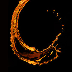 Image showing orange water splash isolated on black
