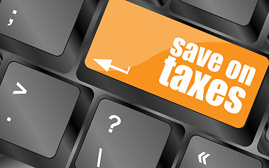 Image showing save on taxes word on laptop keyboard key, business concept