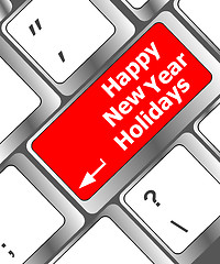 Image showing happy new year holidays button on computer keyboard key