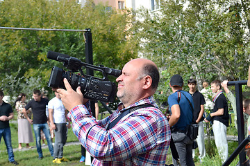 Image showing the video operator behind work
