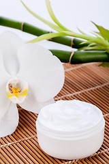 Image showing cosmetic face cream on wooden background 