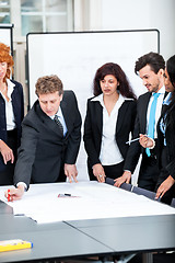 Image showing business people discussing architecture plan sketch 