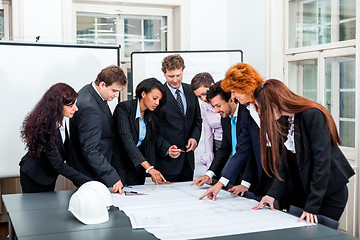 Image showing business people discussing architecture plan sketch 