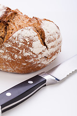 Image showing fresh baked grain bead and knife isolated