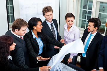 Image showing business people discussing architecture plan sketch 