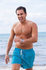 Image showing attractive young athletic man on the beach