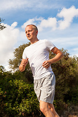 Image showing athletic man runner jogging in nature outdoor