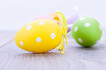 Image showing colorful easter egg decoration on wooden background