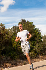 Image showing athletic man runner jogging in nature outdoor