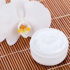 Image showing cosmetic face cream on wooden background 