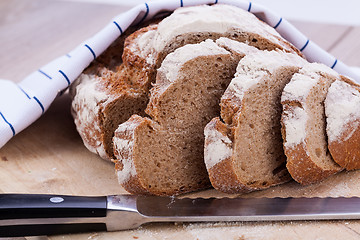 Image showing homemade fresh baked bread and knife 