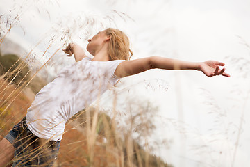 Image showing young happy attractive woman arms wide open 