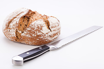 Image showing fresh baked grain bead and knife isolated