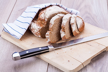 Image showing homemade fresh baked bread and knife 