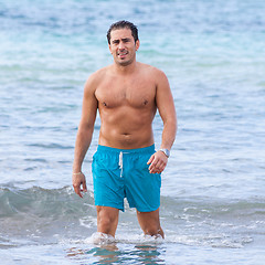 Image showing attractive young athletic man on the beach