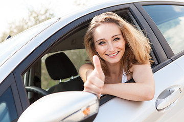 Image showing young attractive happy woman sitting in car summertime