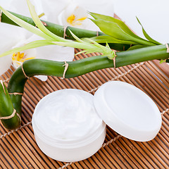 Image showing cosmetic face cream on wooden background 