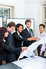Image showing business people discussing architecture plan sketch 