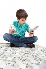 Image showing boy sitting on money, money concept