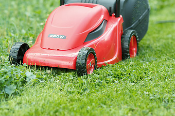 Image showing new lawnmower on green grass