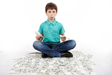 Image showing boy sitting on money, money concept