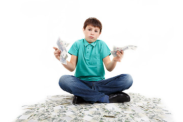 Image showing boy sitting on money