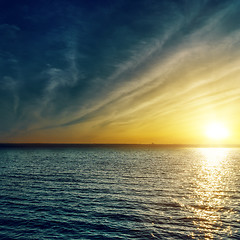 Image showing sunset with clouds over water