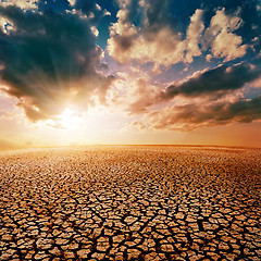 Image showing cracked desert and dramatic sunset