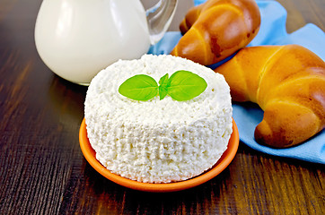 Image showing Curd with basil and bagels on a board