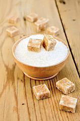 Image showing Sugar brown and white in a wooden bowl on a board