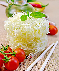 Image showing Noodles rice twisted with oil and vegetables on sacking