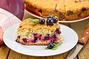 Image showing Pie with berries of black currant and knife on board