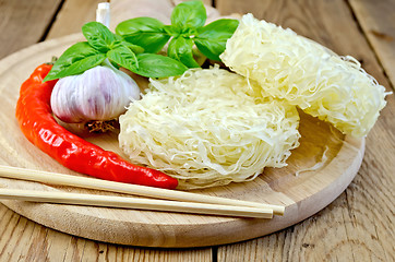 Image showing Noodles rice stranded with spices on the board