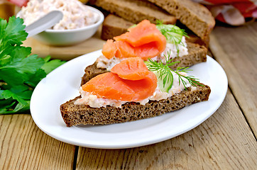 Image showing Sandwich with salmon and cream in a dish with cucumber