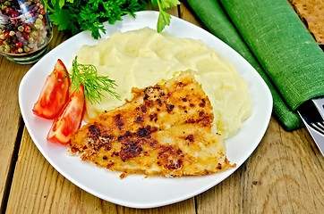 Image showing Fish fried with mashed potatoes on a board