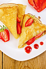 Image showing Pancakes with strawberries and jam on a white plate