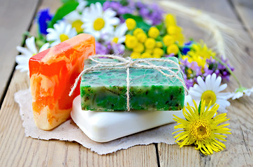 Image showing Soap homemade with wildflowers on the board